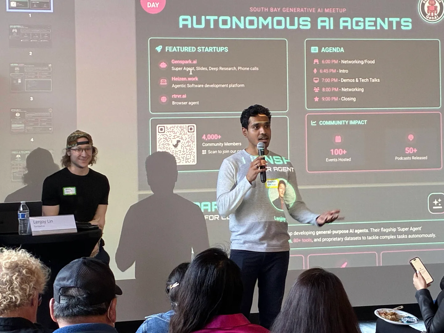 An organizer introducing Genspark in front of the AI Agents event presentation.